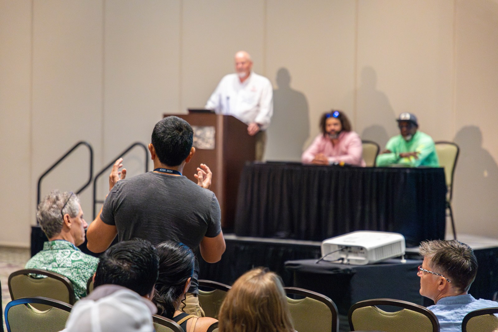 A delegate asking a question during a panel at ICSR 2024